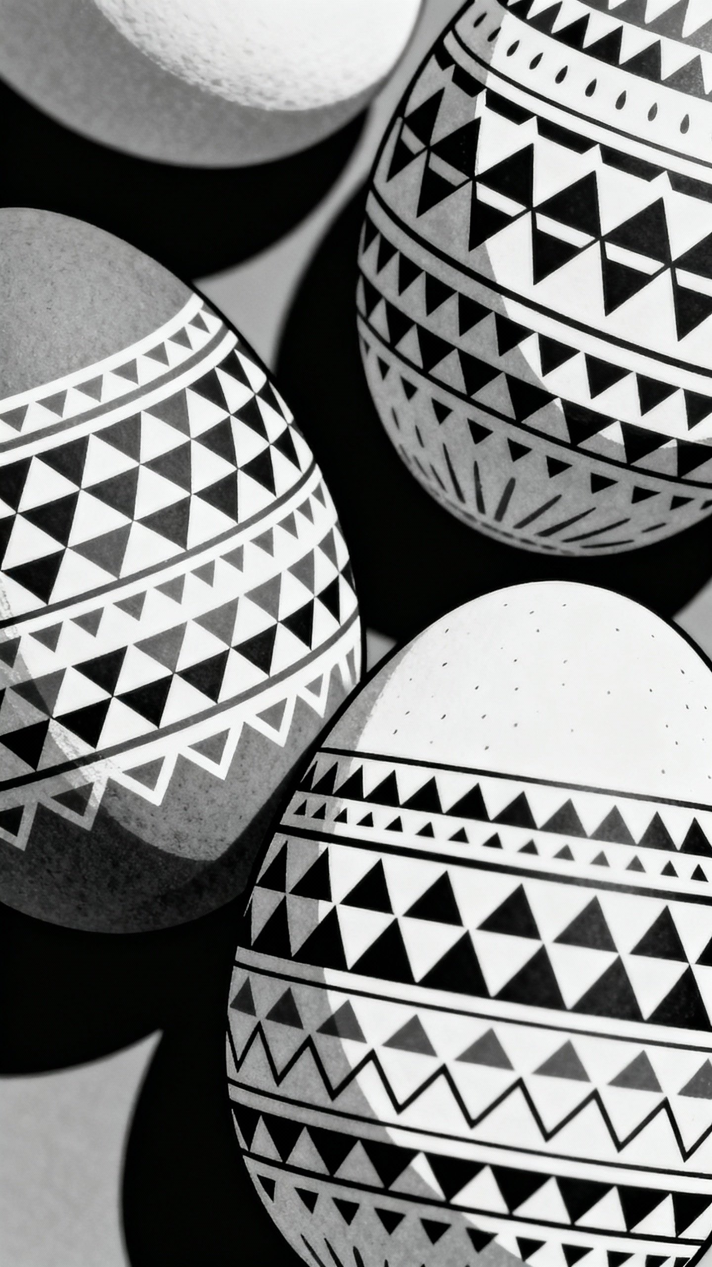 Closeup of decorated Easter eggs, triangle patterns, black-and-white outlines