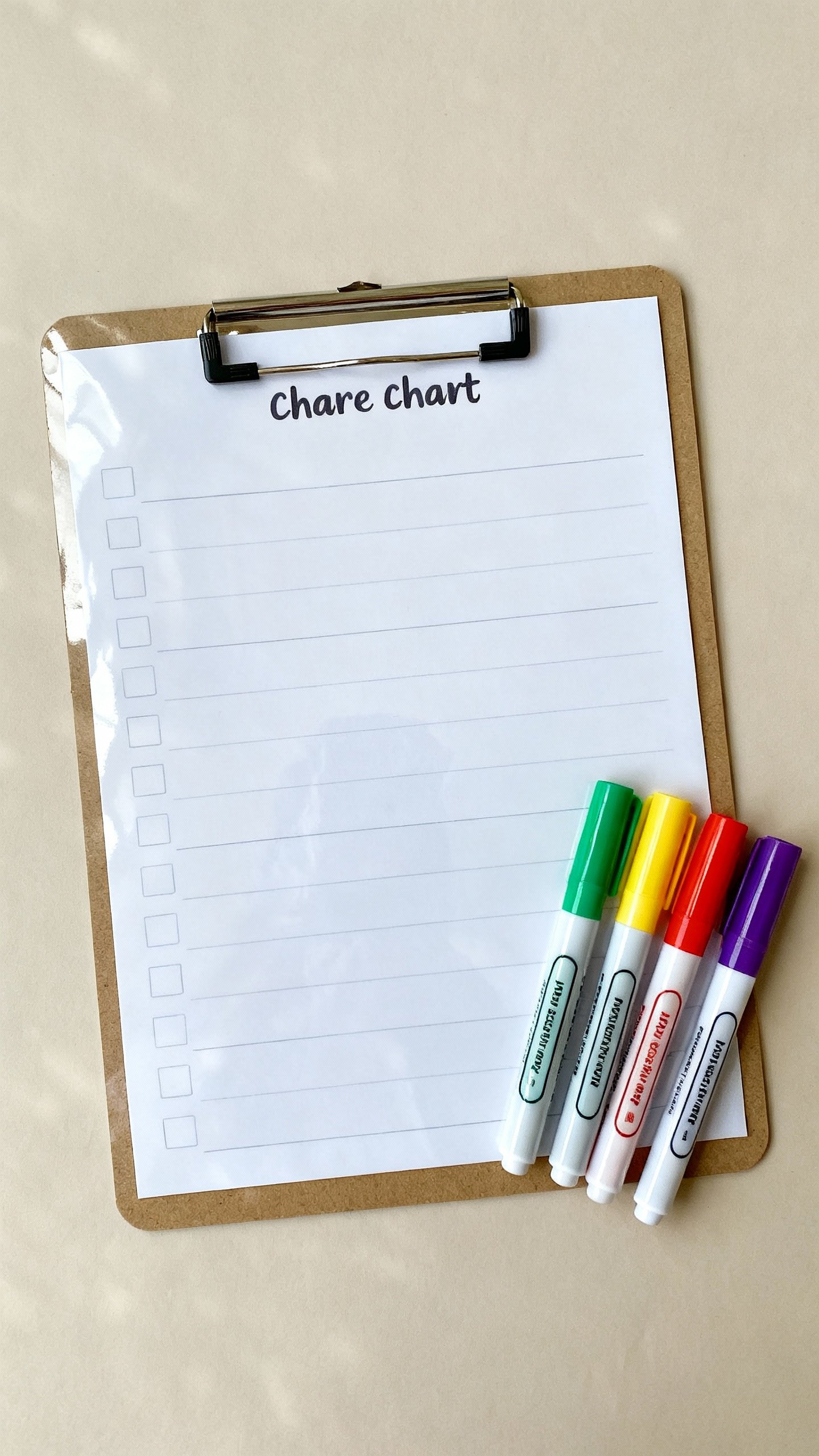 Overhead shot of laminated chore chart with colorful markers beside